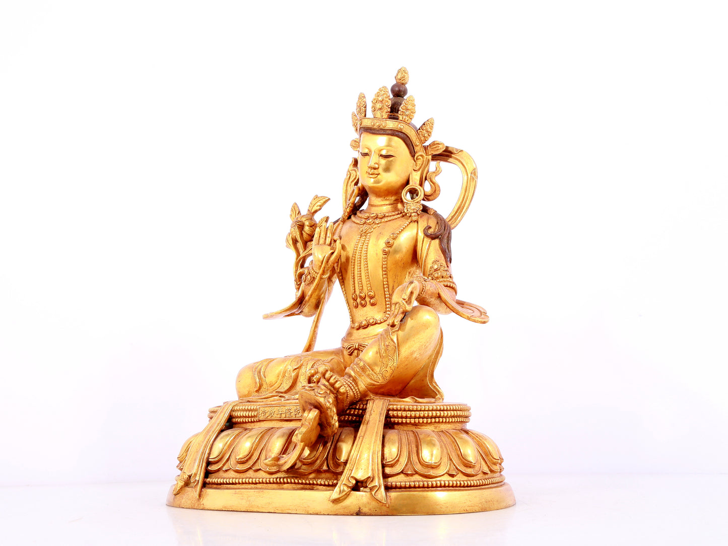 A solemn gilt bronze statue of green Tara