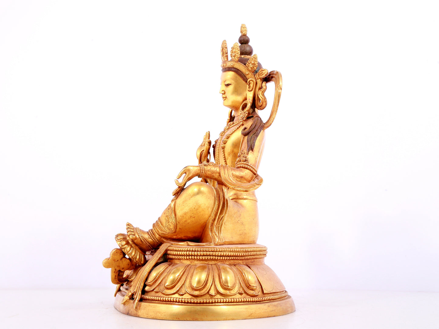 A solemn gilt bronze statue of green Tara