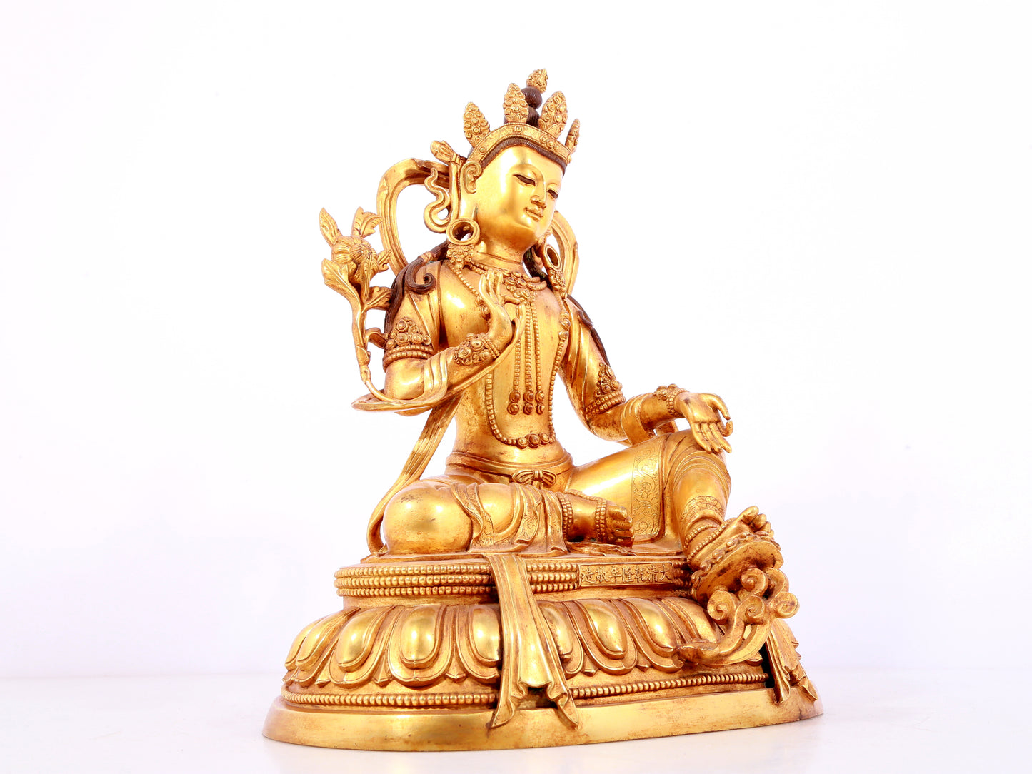 A solemn gilt bronze statue of green Tara