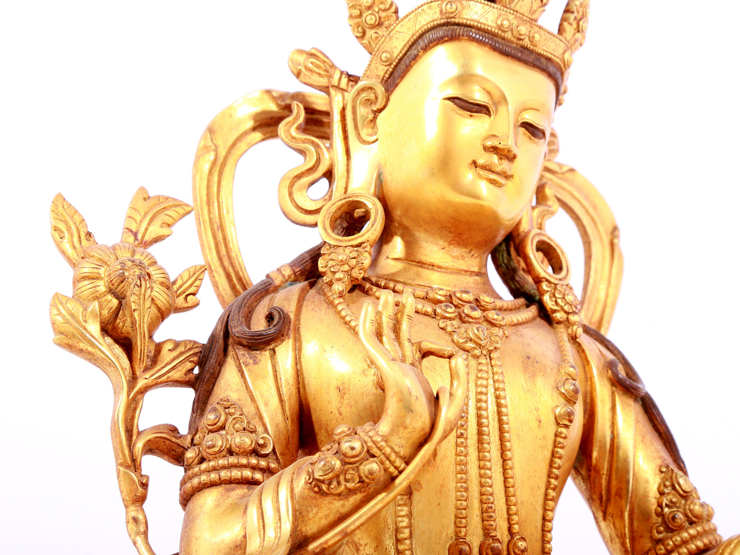 A solemn gilt bronze statue of green Tara