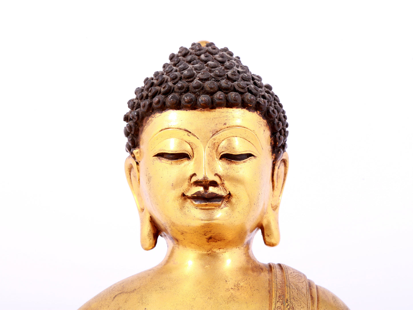 A solemn gilt bronze statue of Sakyamuni