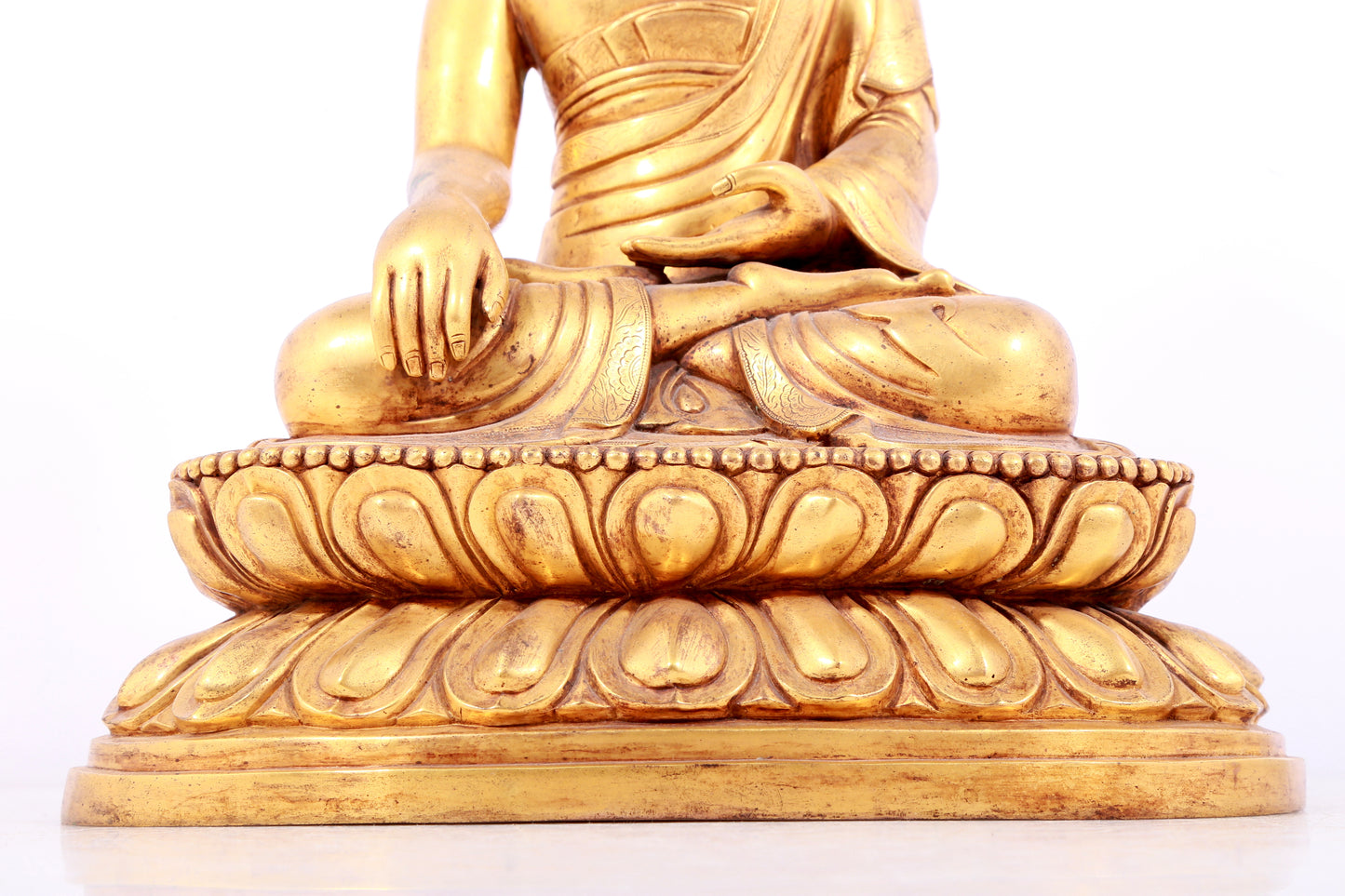 A solemn gilt bronze statue of Sakyamuni