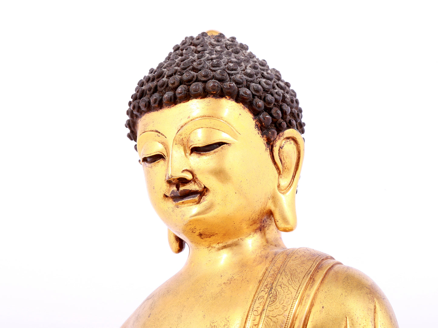 A solemn gilt bronze statue of Sakyamuni