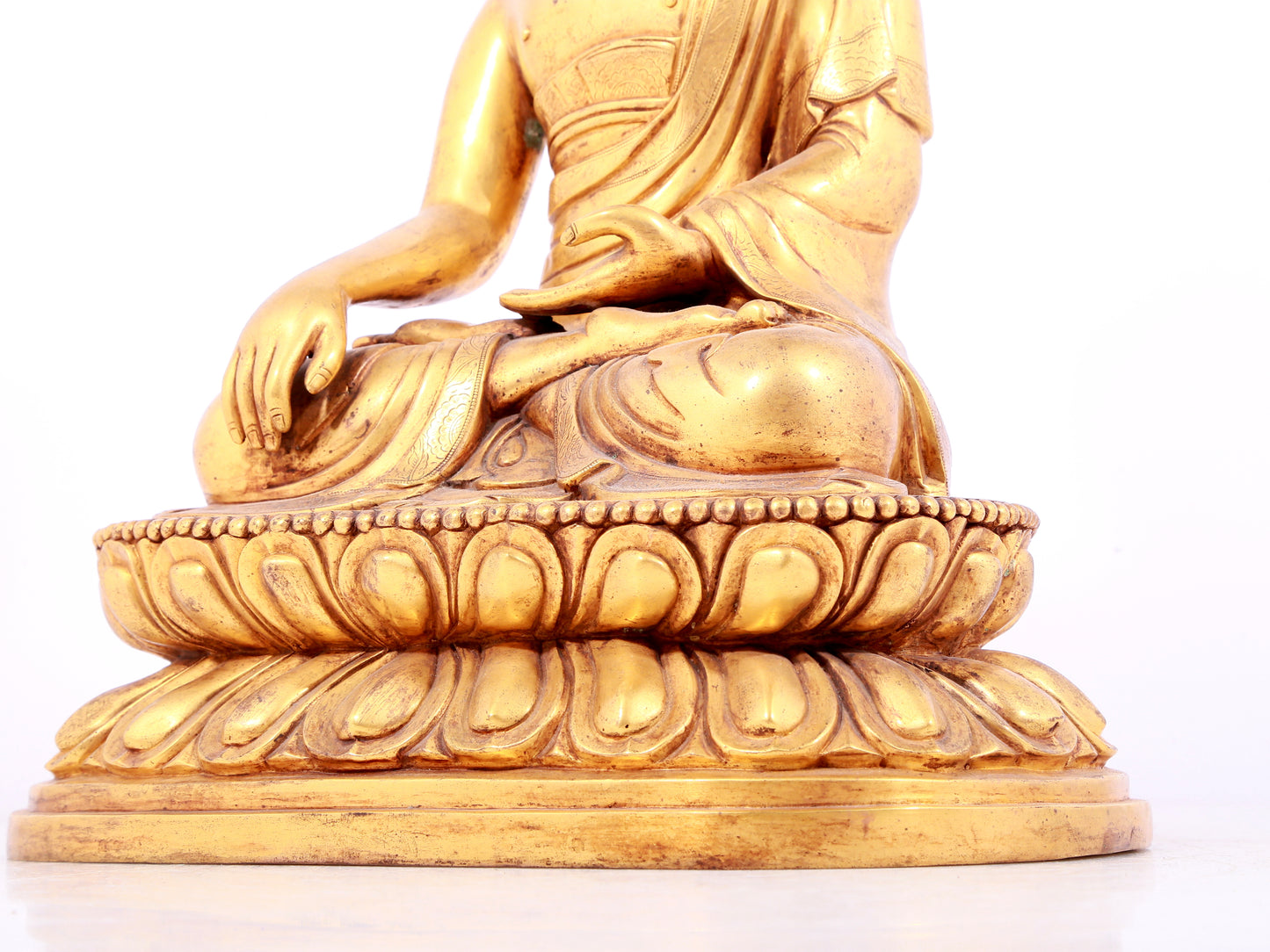 A solemn gilt bronze statue of Sakyamuni