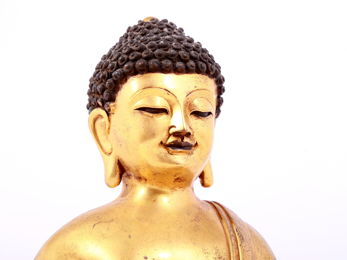 A solemn gilt bronze statue of Sakyamuni