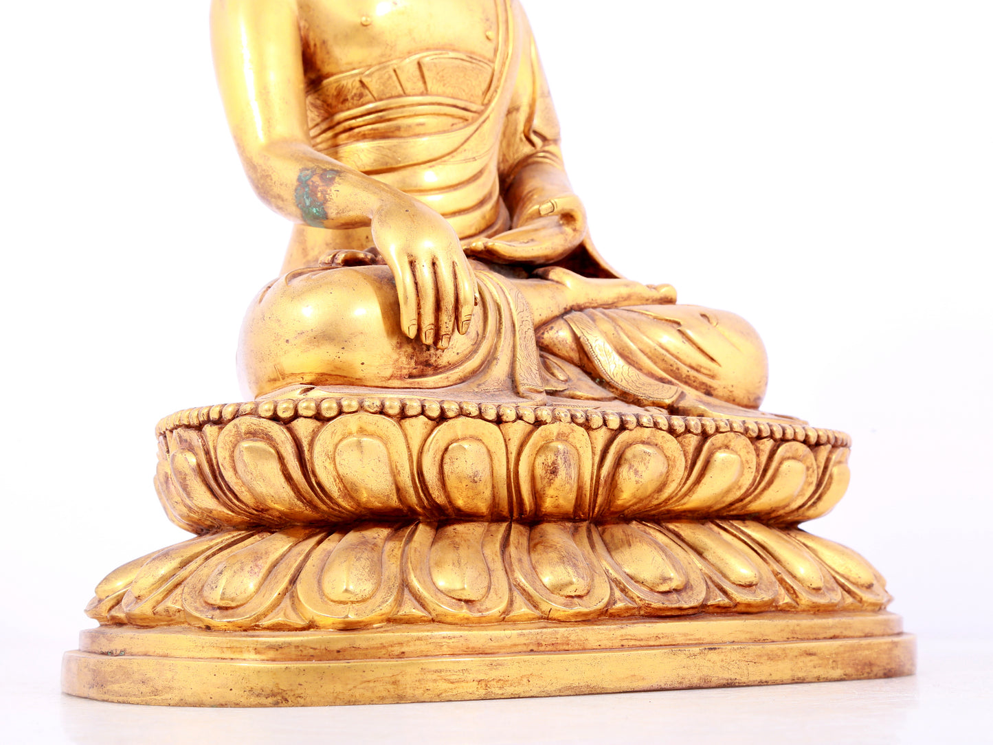 A solemn gilt bronze statue of Sakyamuni