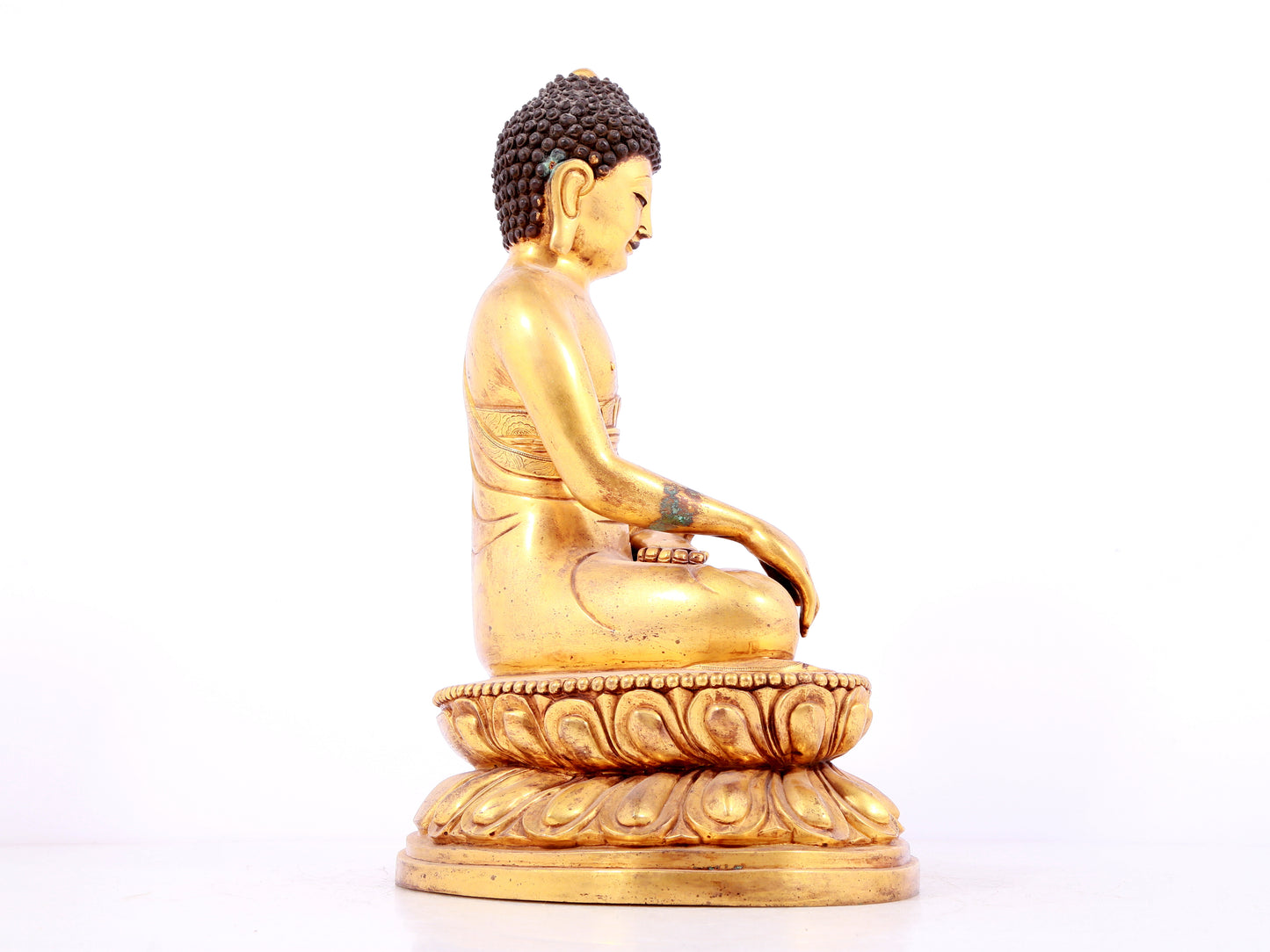 A solemn gilt bronze statue of Sakyamuni