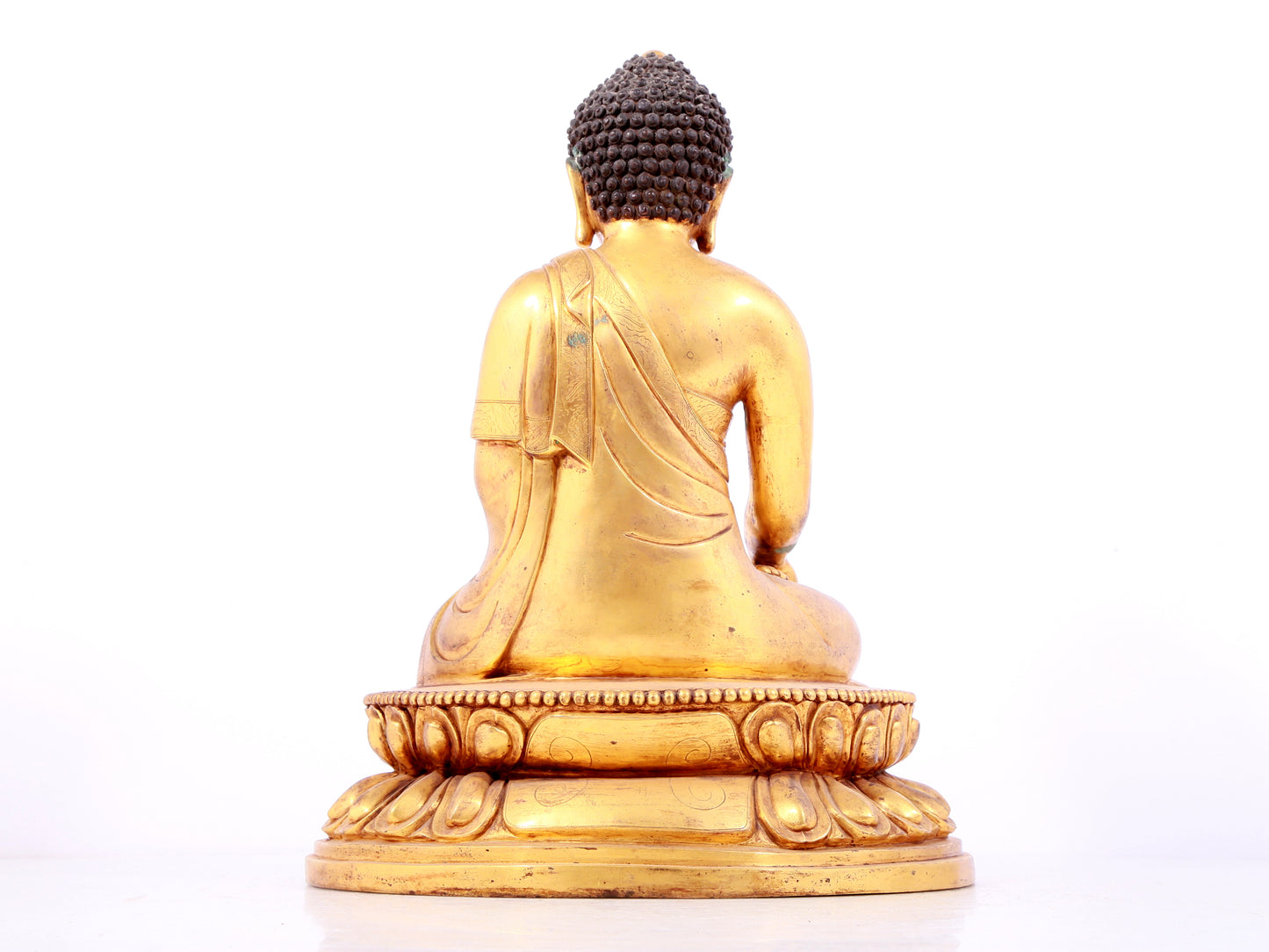 A solemn gilt bronze statue of Sakyamuni