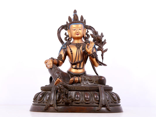 A solemn gilt bronze statue of green Tara