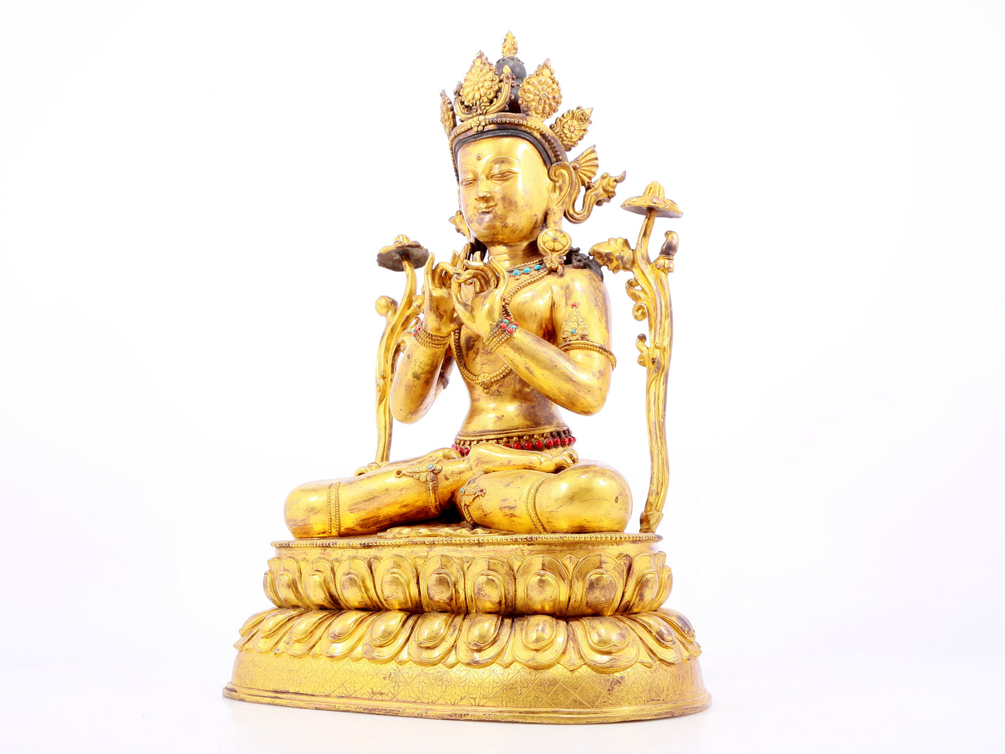 A gilt bronze statue of Tara inlaid with hundreds of treasures