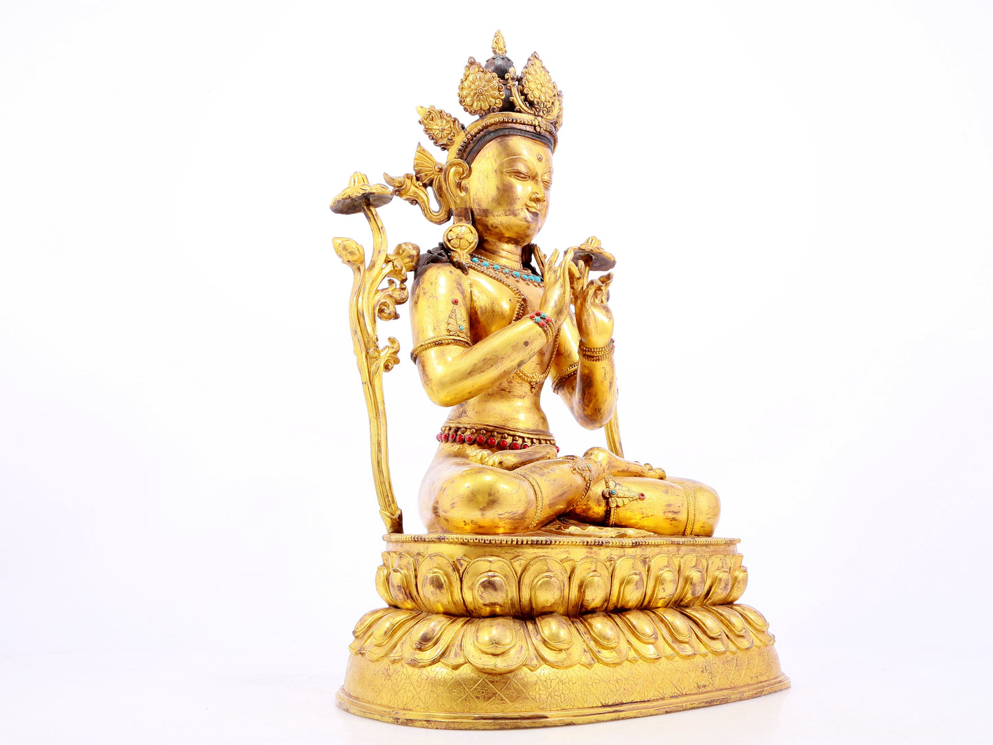 A gilt bronze statue of Tara inlaid with hundreds of treasures