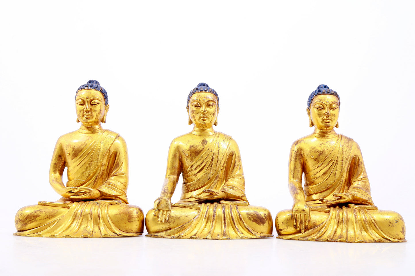 Three Magnificent Gilt-Bronze Figures Of Buddha