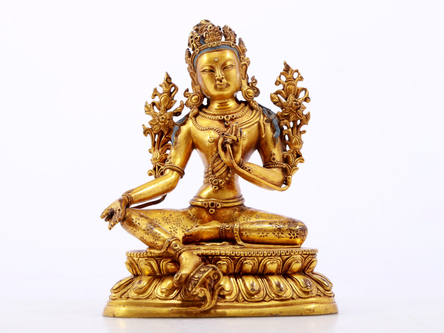 A serene gilt bronze green Tara statue