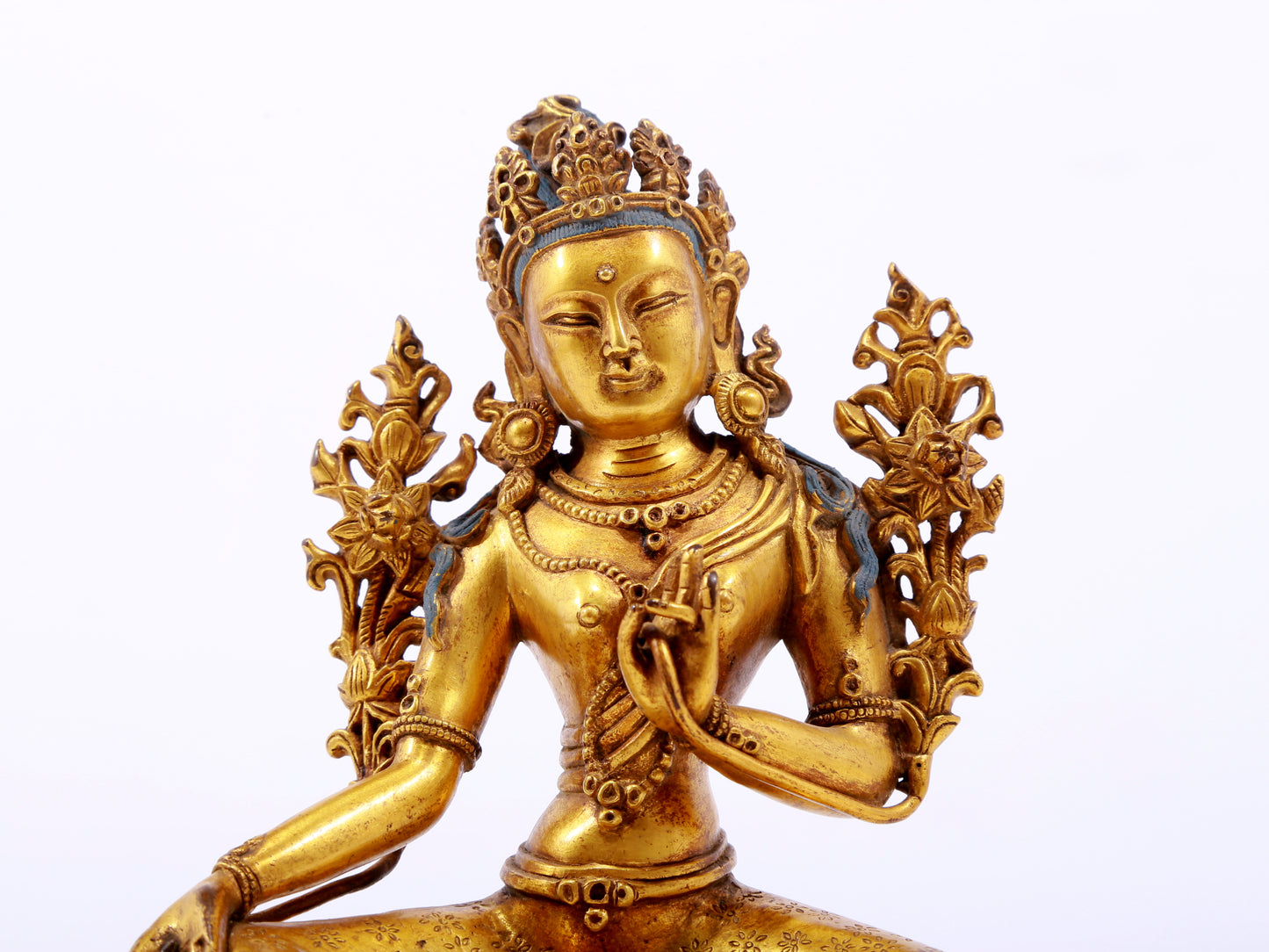 A serene gilt bronze green Tara statue