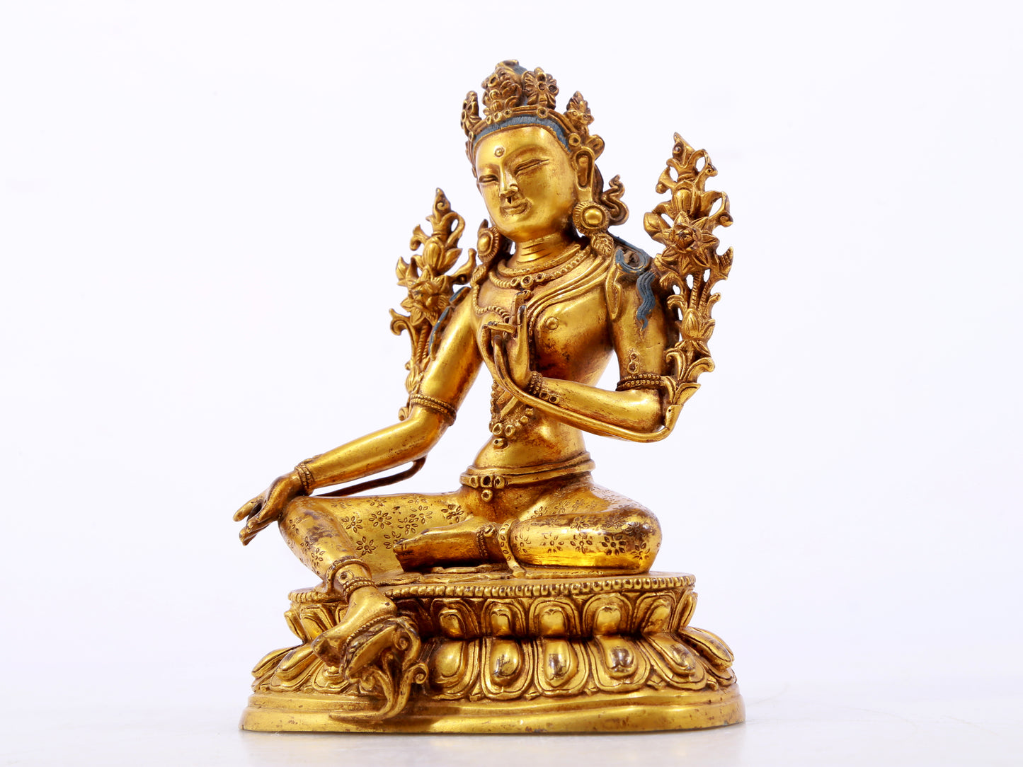 A serene gilt bronze green Tara statue