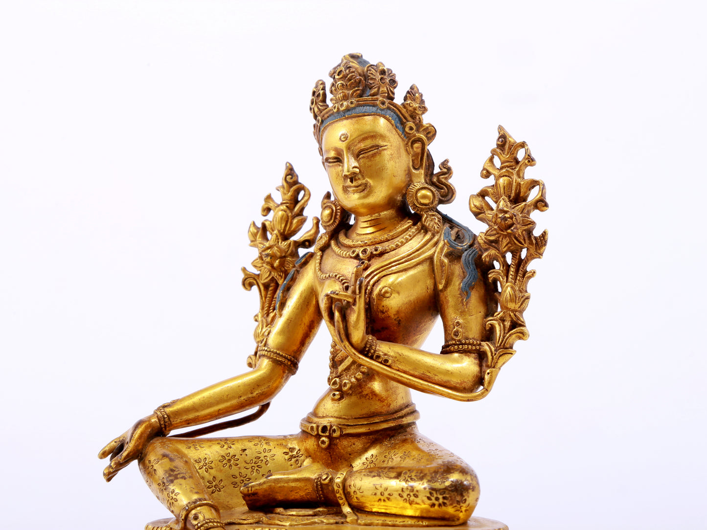 A serene gilt bronze green Tara statue