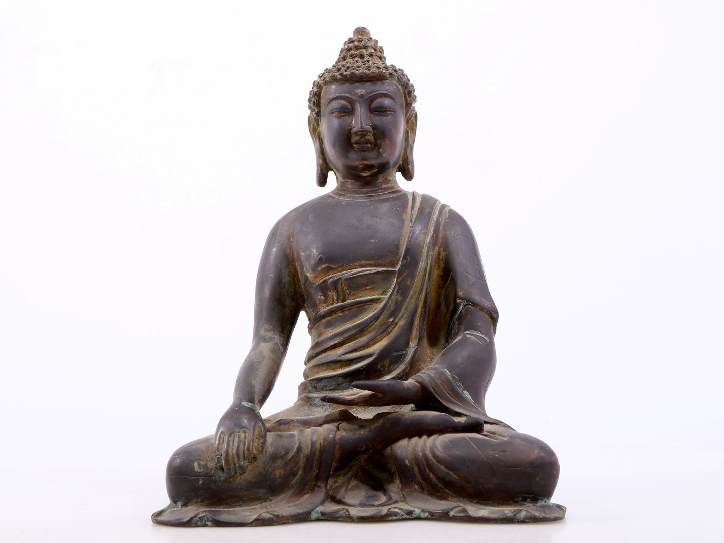 A serene gilt bronze statue of Gautama Buddha