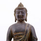 A serene gilt bronze statue of Gautama Buddha