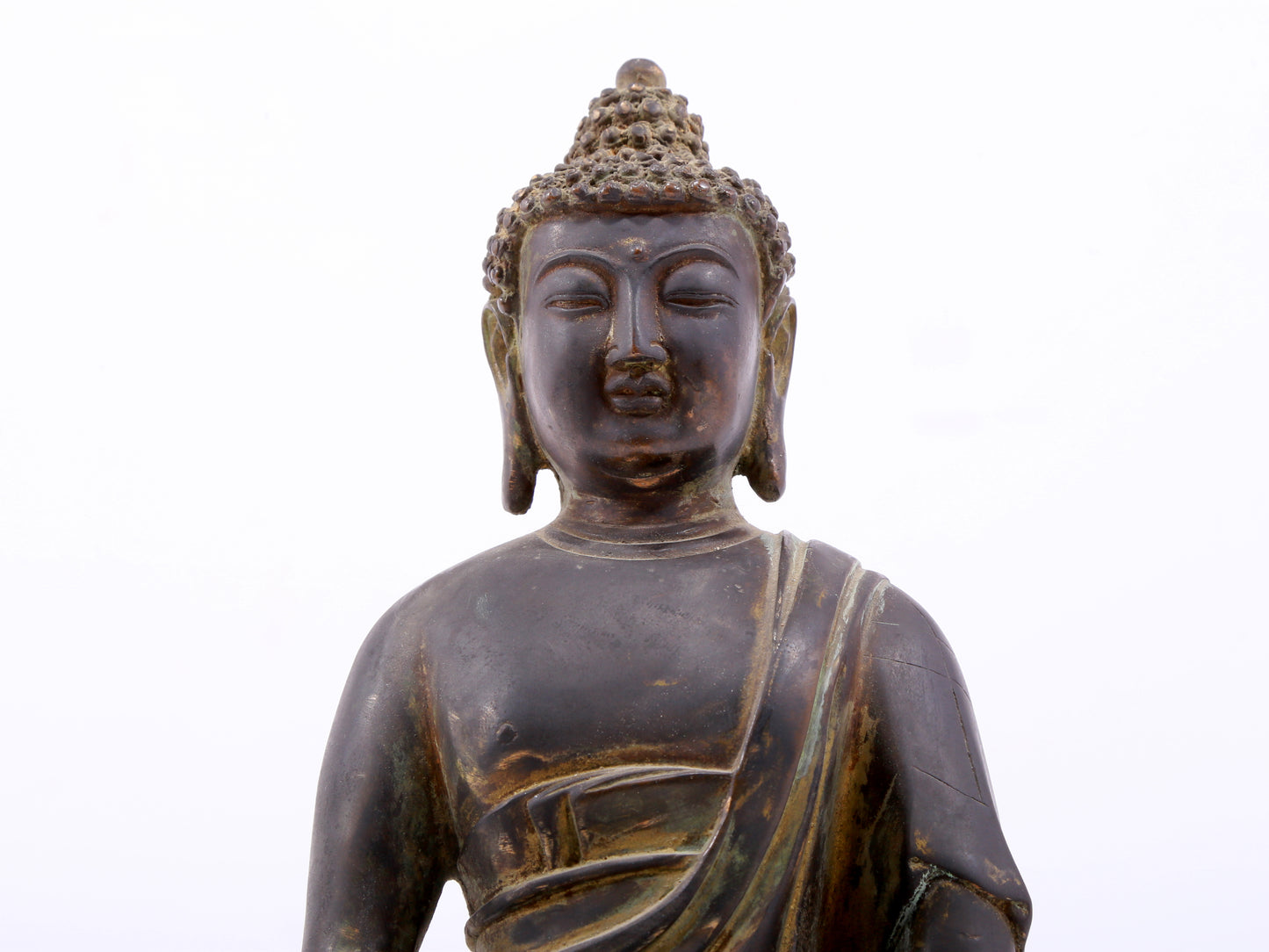 A serene gilt bronze statue of Gautama Buddha