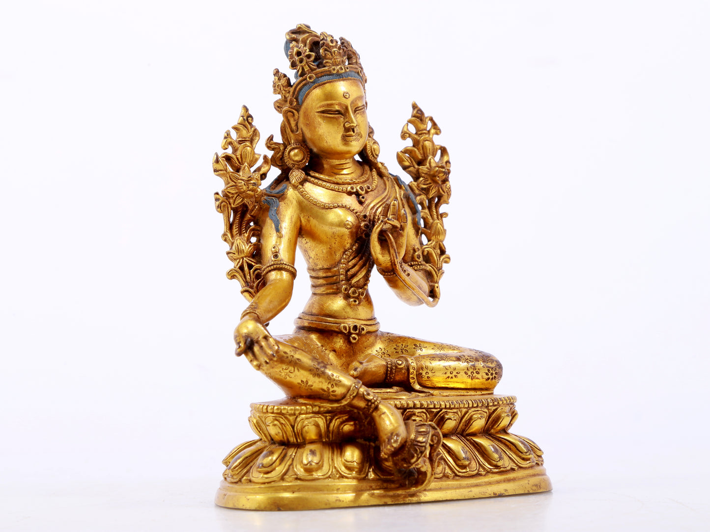 A serene gilt bronze green Tara statue