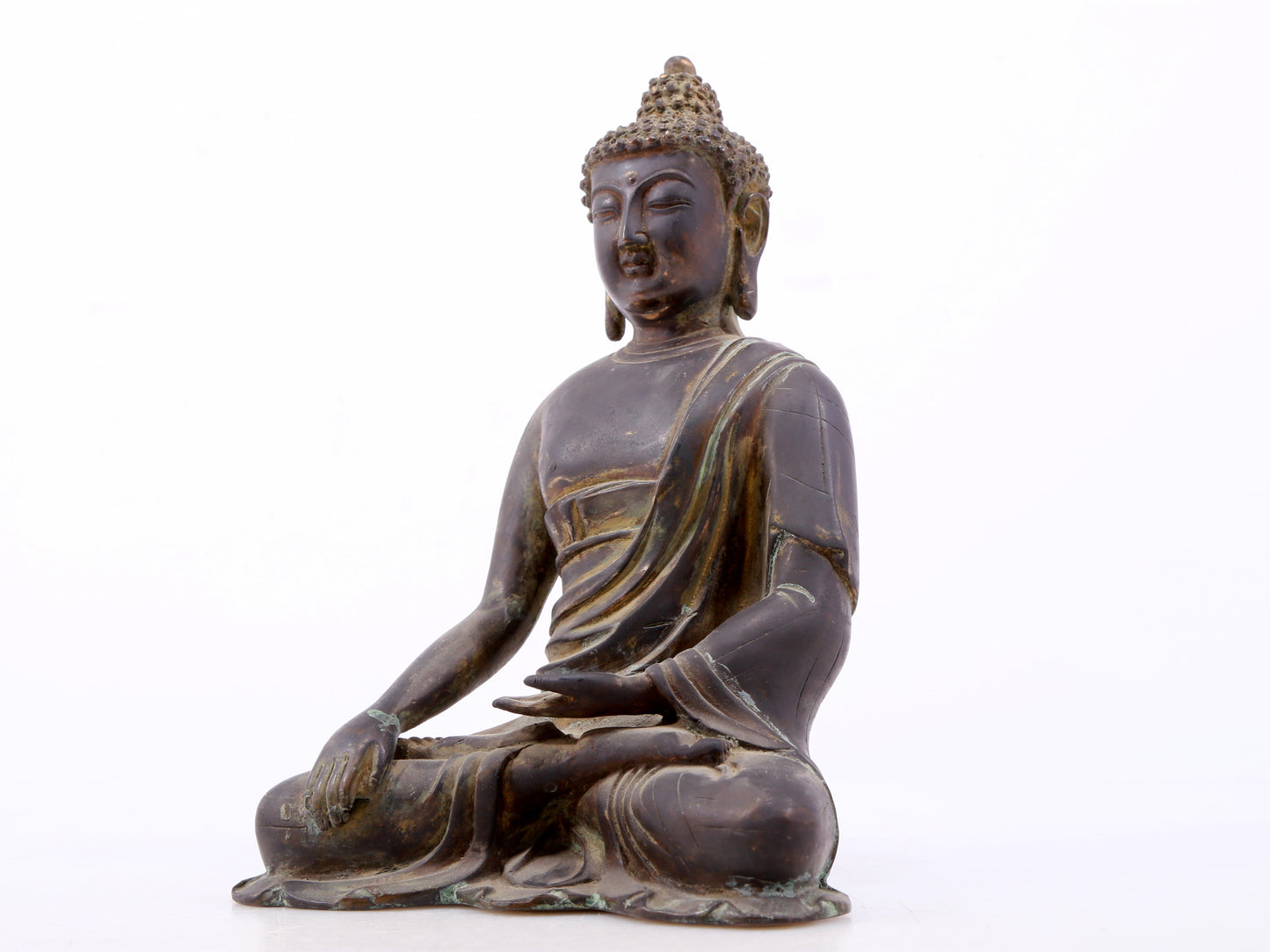 A serene gilt bronze statue of Gautama Buddha