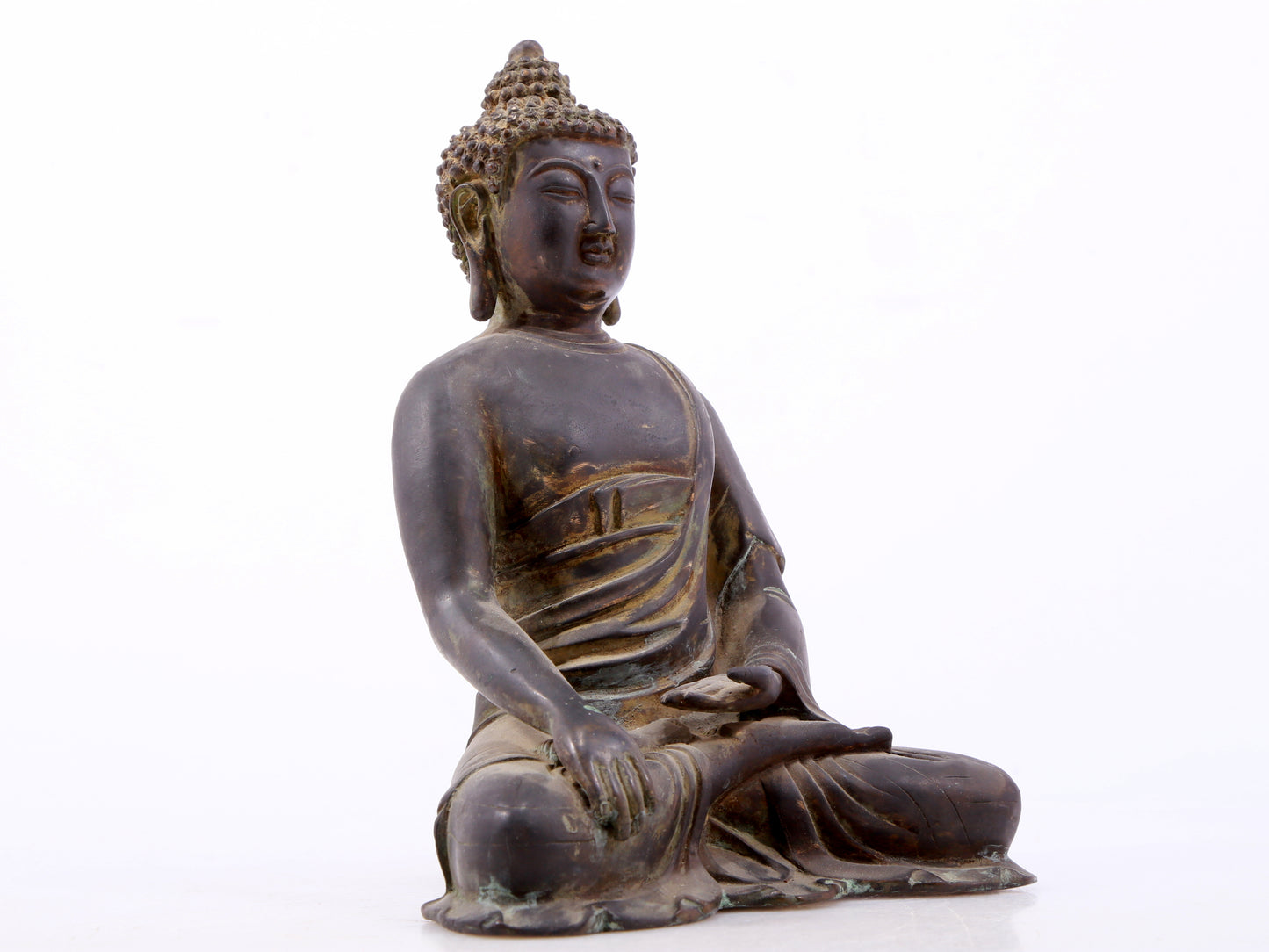 A serene gilt bronze statue of Gautama Buddha