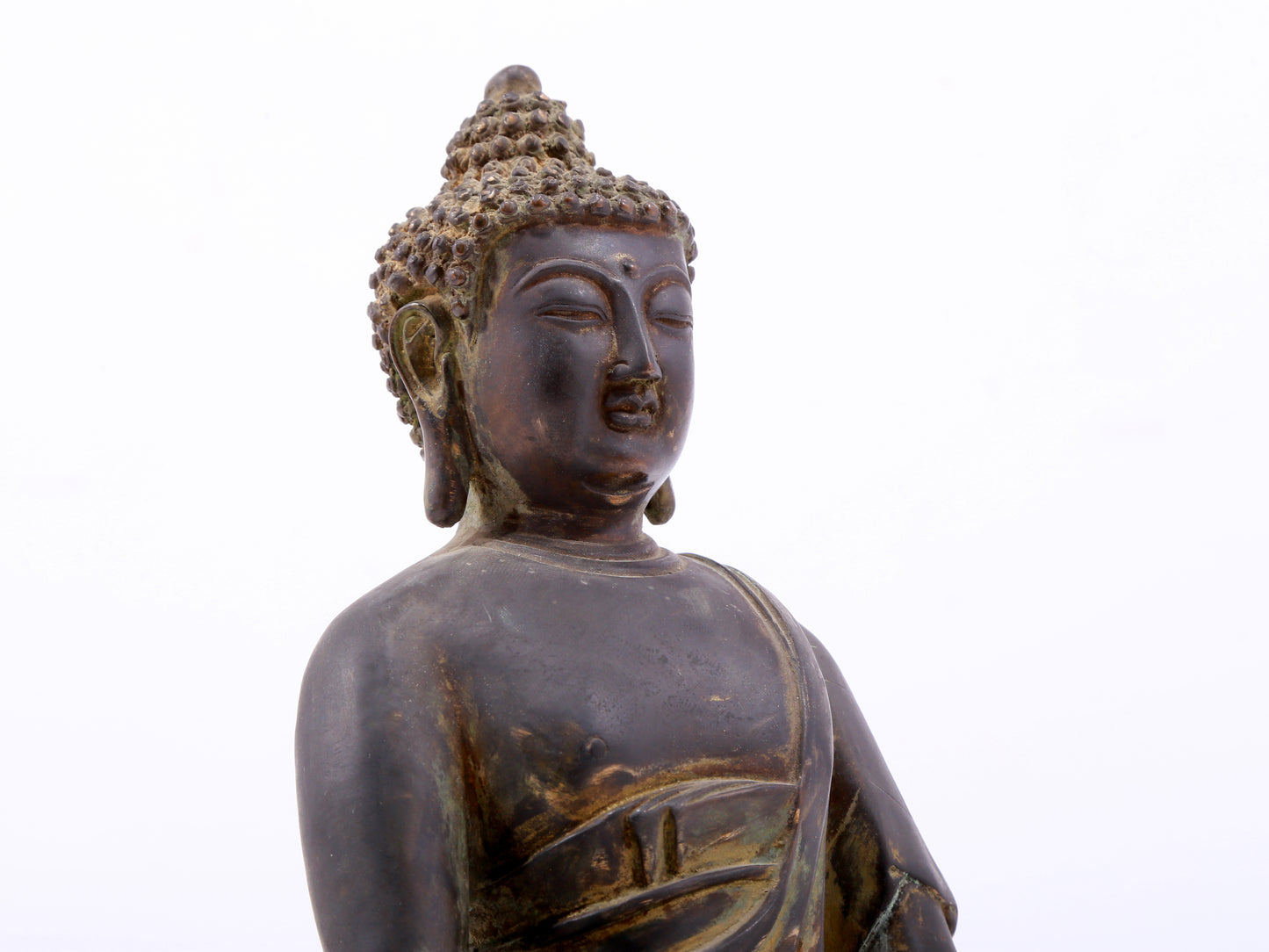 A serene gilt bronze statue of Gautama Buddha