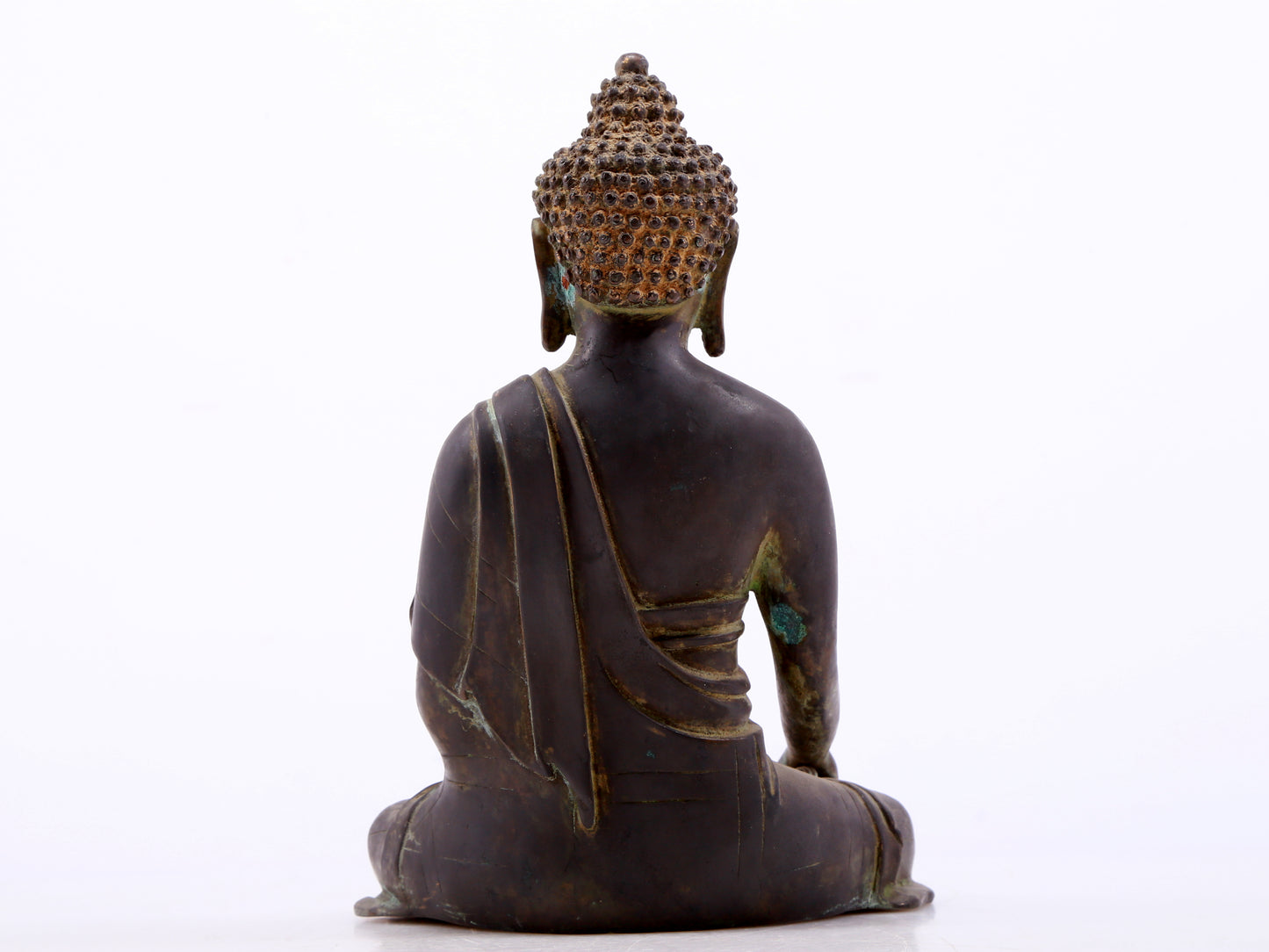 A serene gilt bronze statue of Gautama Buddha