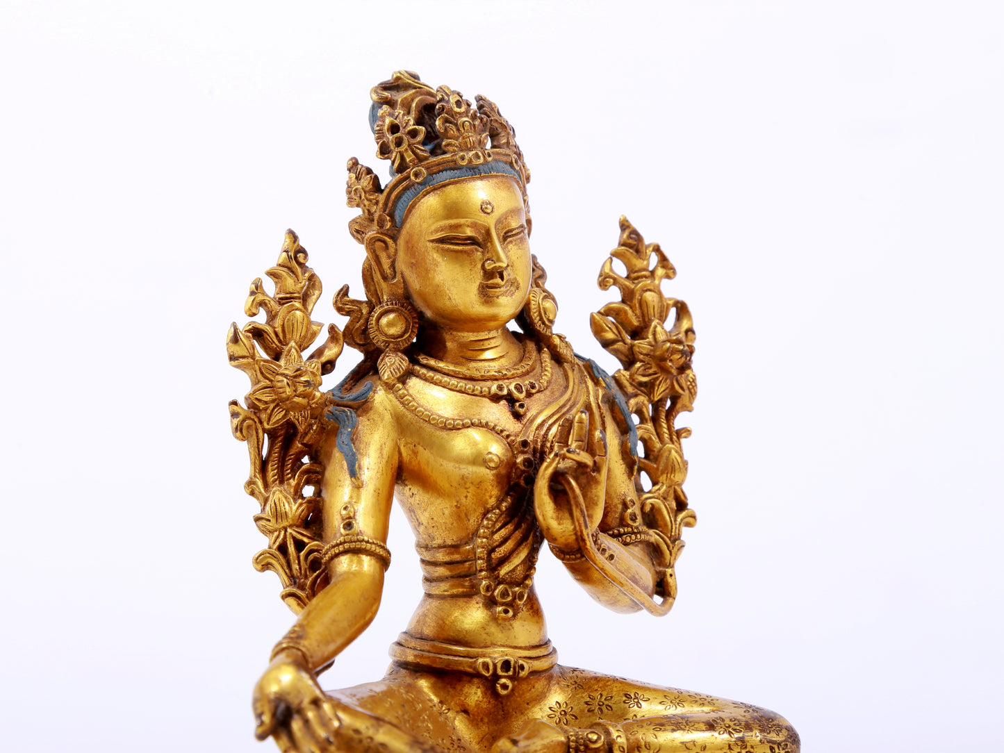 A serene gilt bronze green Tara statue