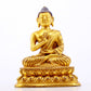 A serene gilt bronze statue of Gautama Buddha