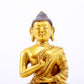 A serene gilt bronze statue of Gautama Buddha