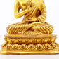 A serene gilt bronze statue of Gautama Buddha