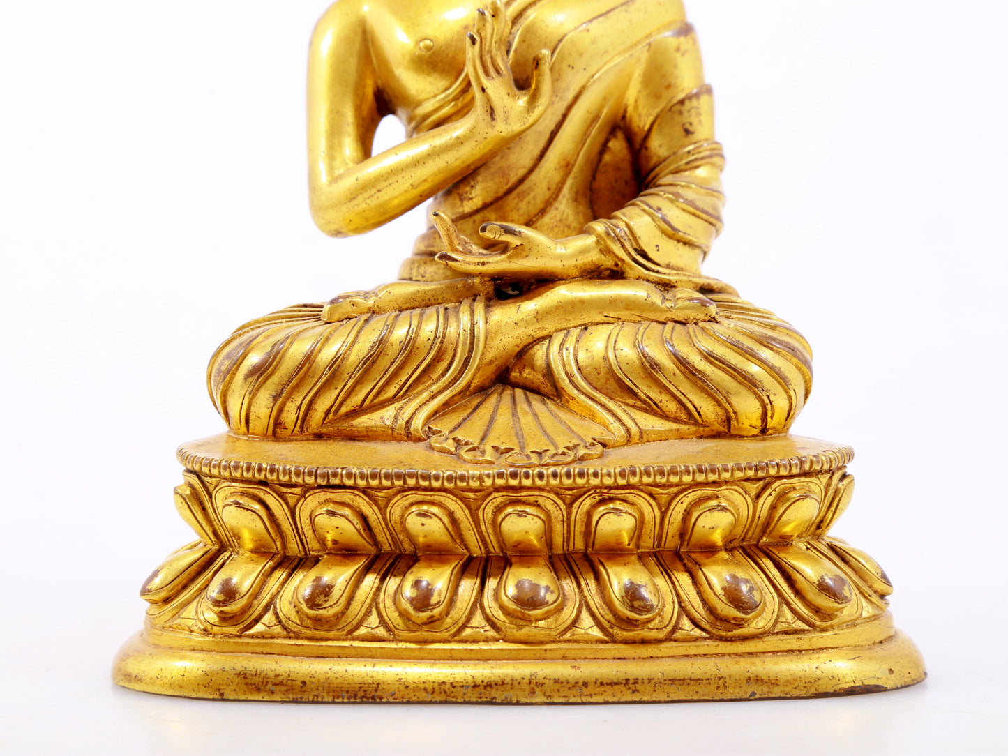 A serene gilt bronze statue of Gautama Buddha