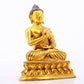 A serene gilt bronze statue of Gautama Buddha