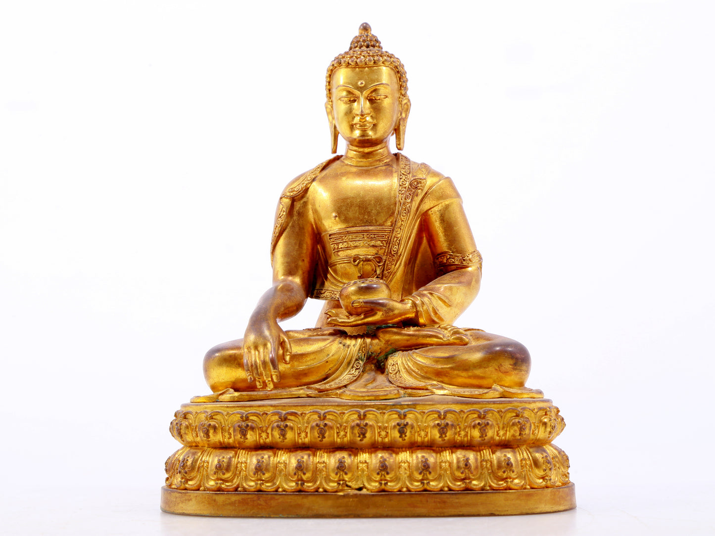 A serene gilt bronze statue of Gautama Buddha