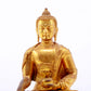 A serene gilt bronze statue of Gautama Buddha