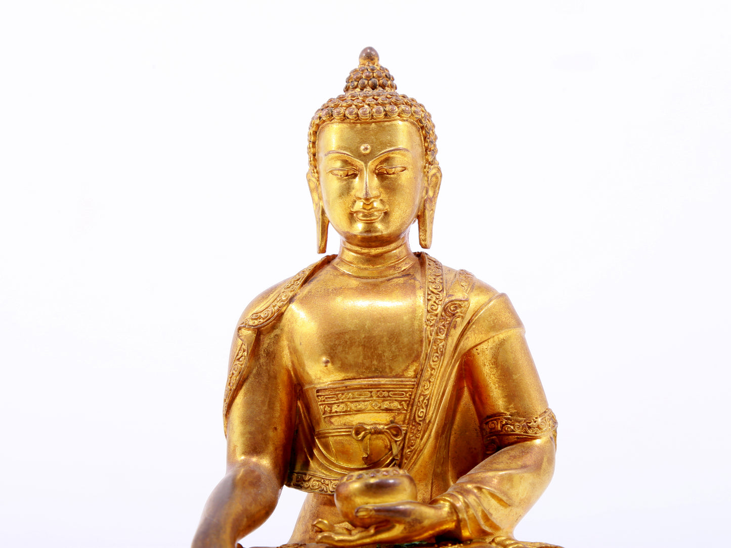 A serene gilt bronze statue of Gautama Buddha