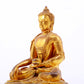 A serene gilt bronze statue of Gautama Buddha