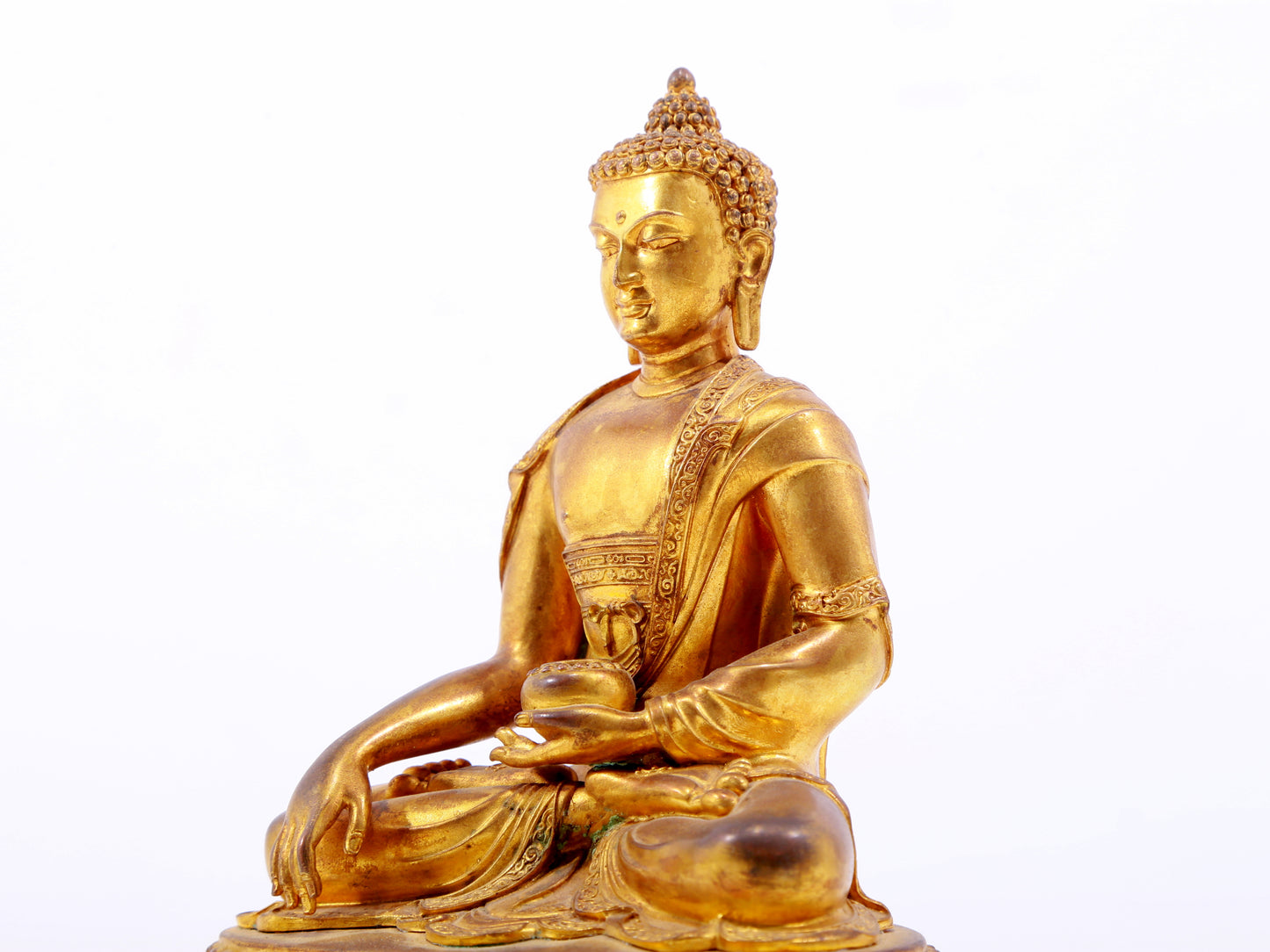 A serene gilt bronze statue of Gautama Buddha