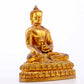 A serene gilt bronze statue of Gautama Buddha