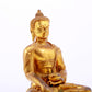 A serene gilt bronze statue of Gautama Buddha