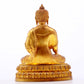 A serene gilt bronze statue of Gautama Buddha