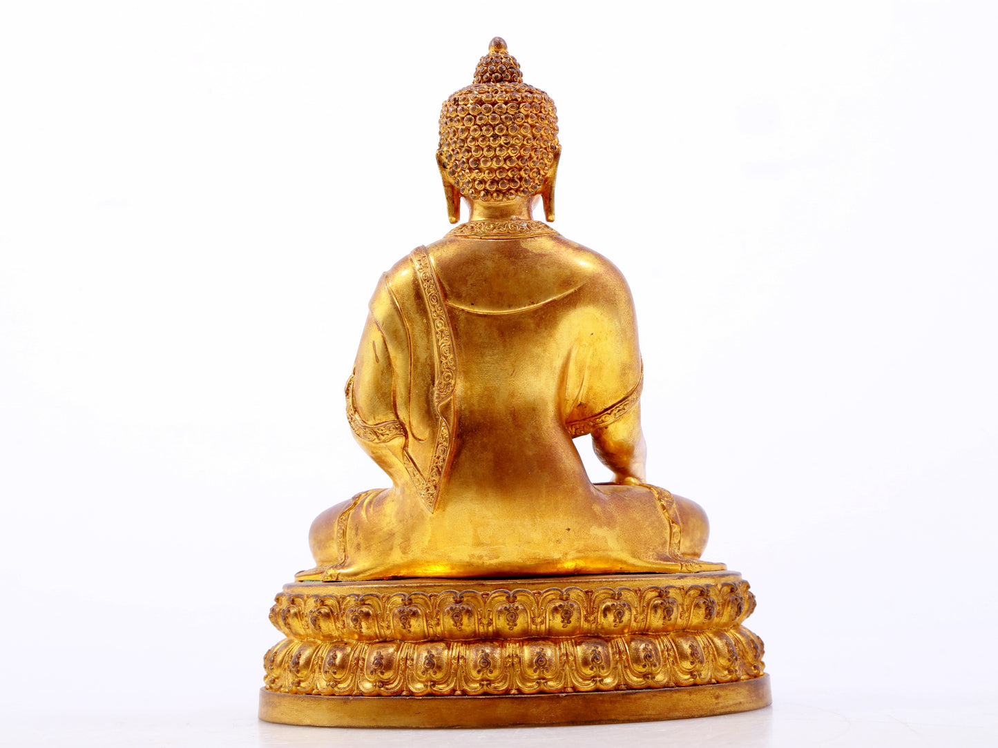 A serene gilt bronze statue of Gautama Buddha