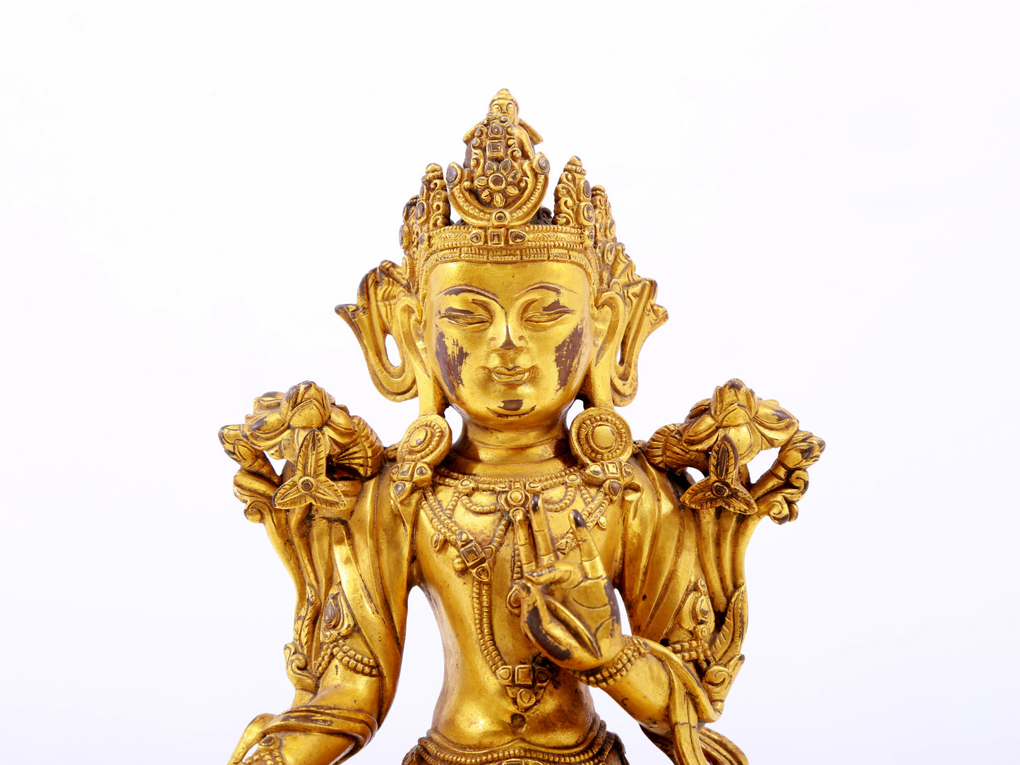 A serene gilt bronze green Tara statue