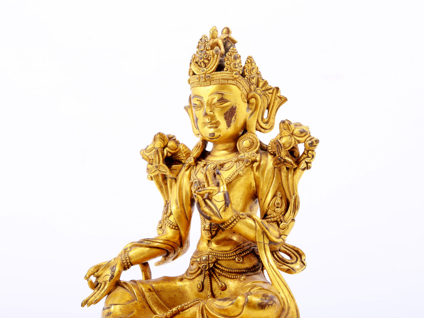 A serene gilt bronze green Tara statue