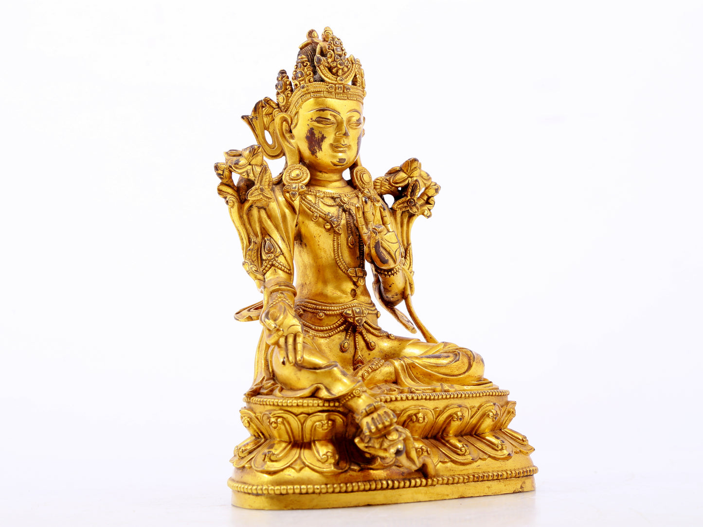 A serene gilt bronze green Tara statue