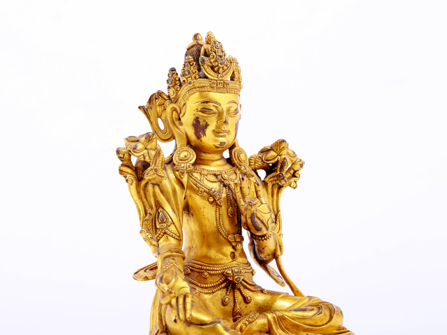 A serene gilt bronze green Tara statue