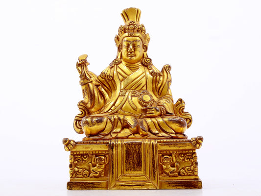 A serene gilt bronze statue of the Guru