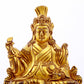 A serene gilt bronze statue of the Guru