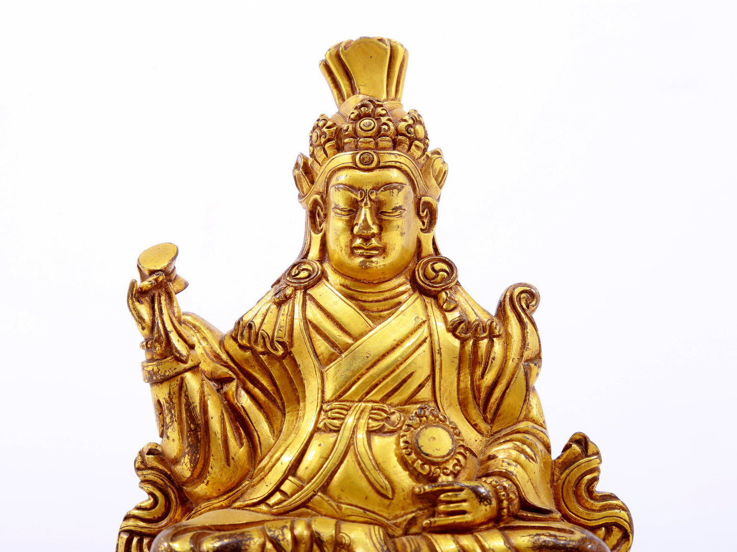 A serene gilt bronze statue of the Guru